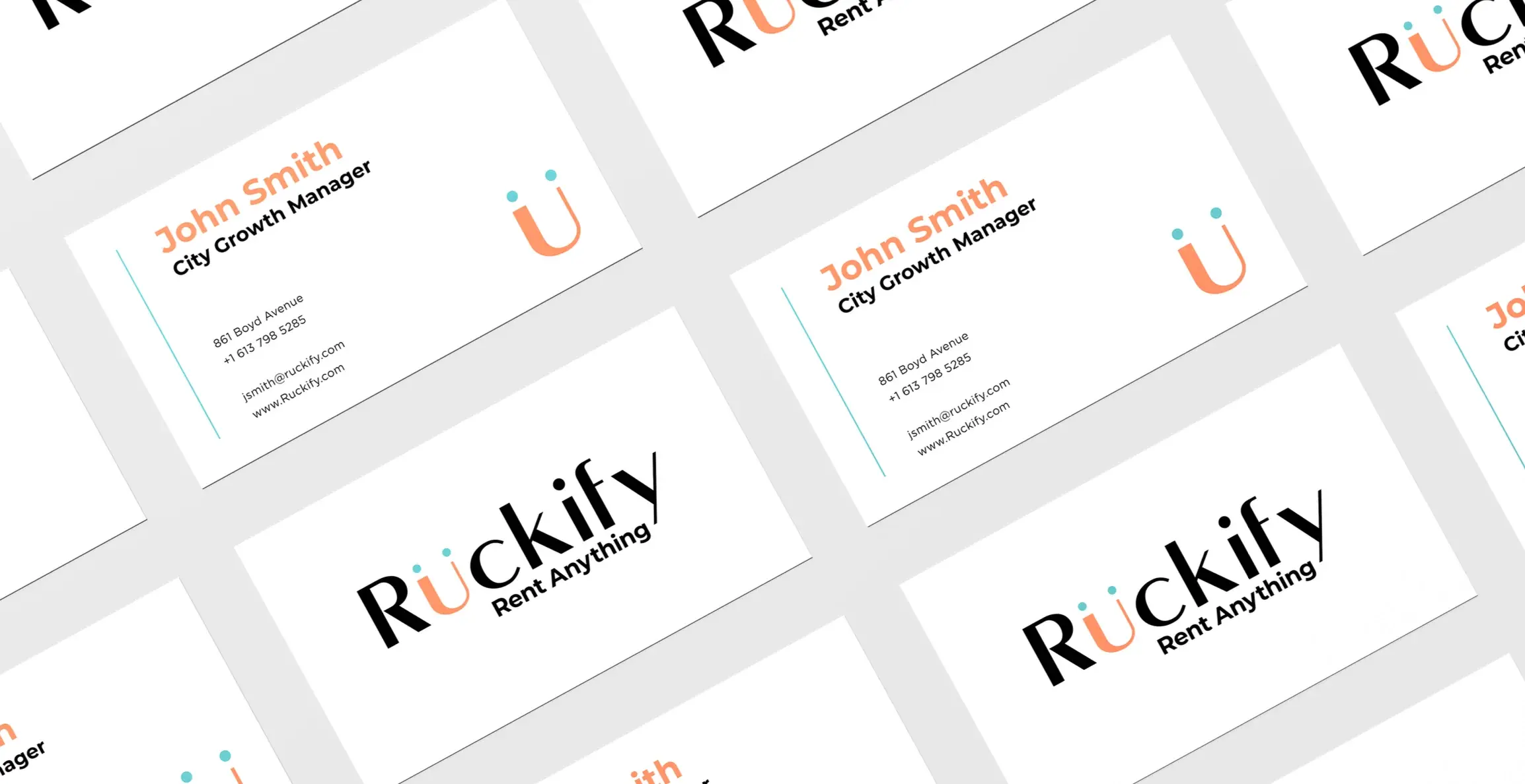 Business cards scattered face up and face down, the wordmark and ü monogram in coral and teal on white.