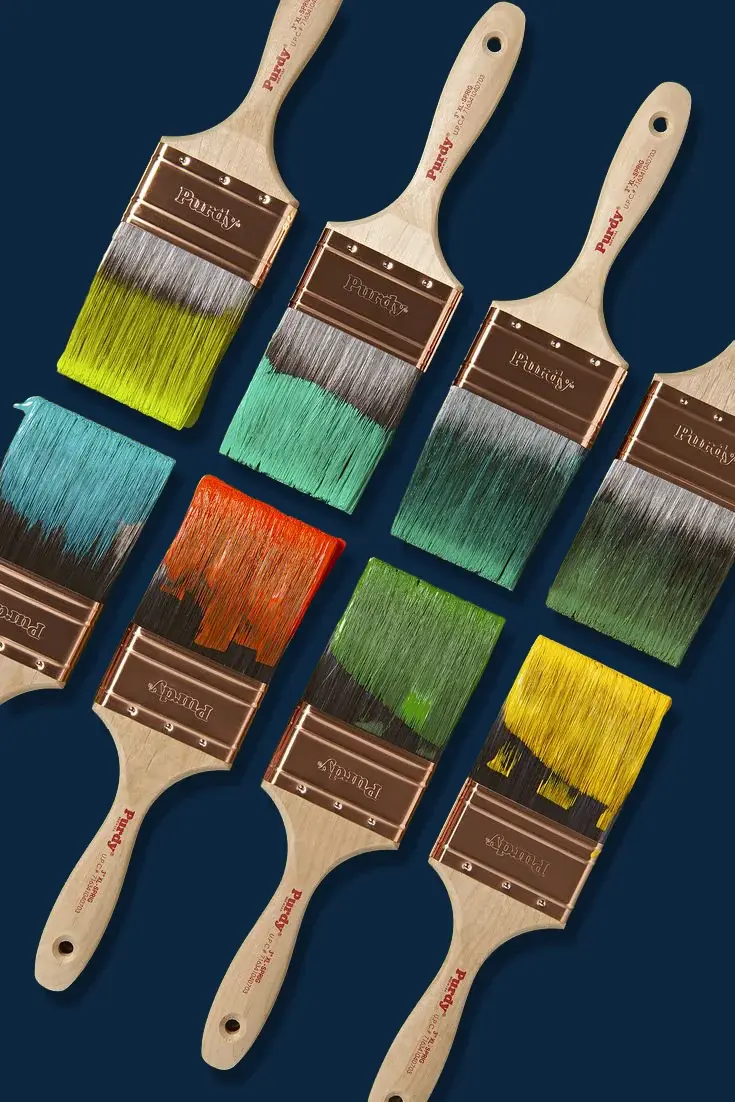 Six paintbrushes on navy, each loaded with a different colour — green, teal, orange, red, blue and yellow — over swatch cards of the same shades.
