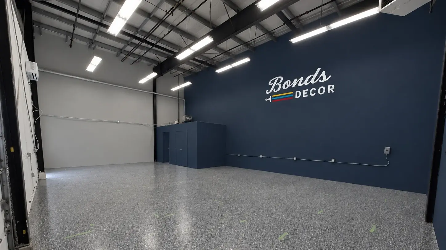 The new store interior, the Bonds Decor logo painted large in cream across a deep navy wall above the polished concrete floor.